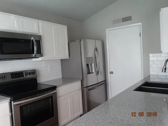 a kitchen with a refrigerator stove and microwave