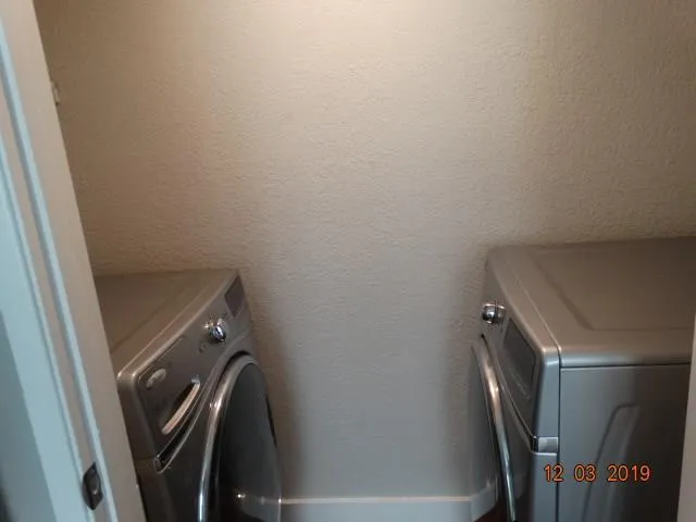 a view of a storage and utility room with washer and dryer
