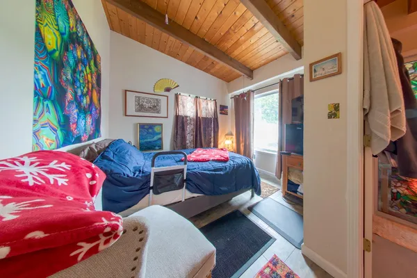 a bed room with a bed and a painting on the wall