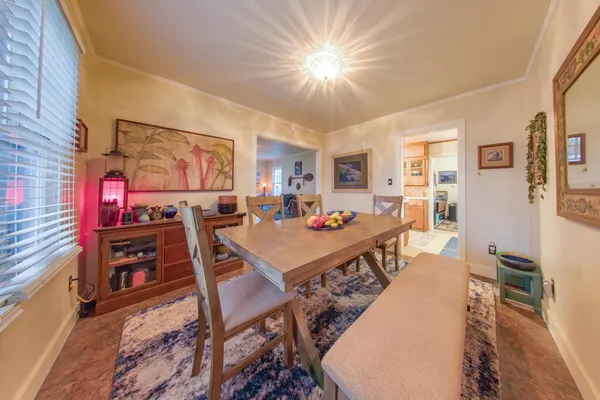 a living room with furniture a dining table and chairs