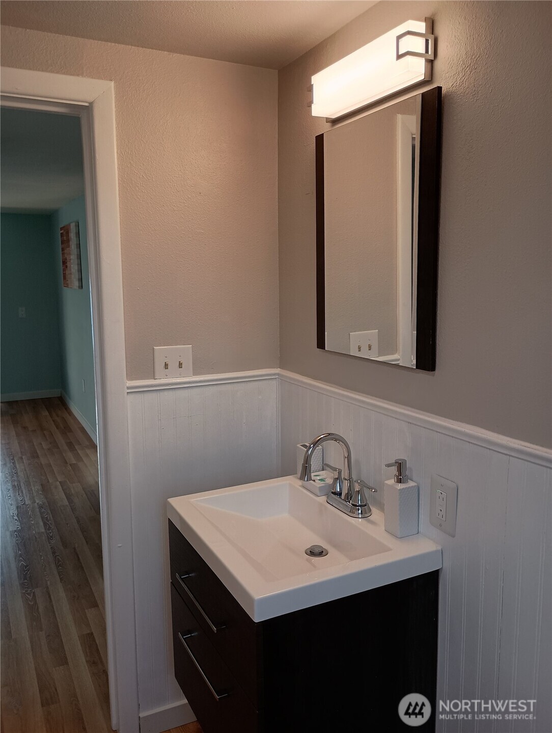 14607 Union Avenue Southwest Lakewood, WA 98498 - Photo 12 of 40 a bathroom with a sink a mirror and vanity