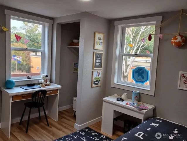 a view of a workspace with furniture and a window