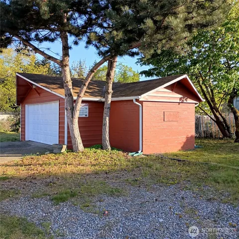 a front view of house with yard and trees