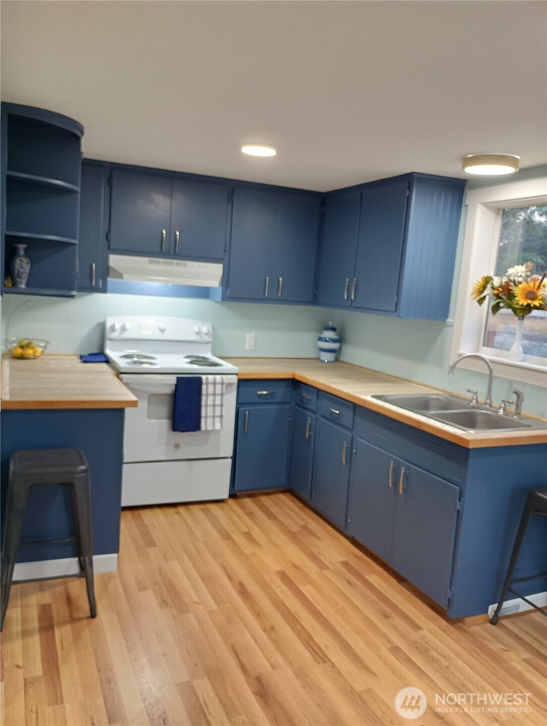 14607 Union Avenue Southwest Lakewood, WA 98498 - Photo 21 of 40 a kitchen with a sink a stove and cabinets