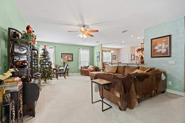 a living room with furniture a chandelier and a flat screen tv
