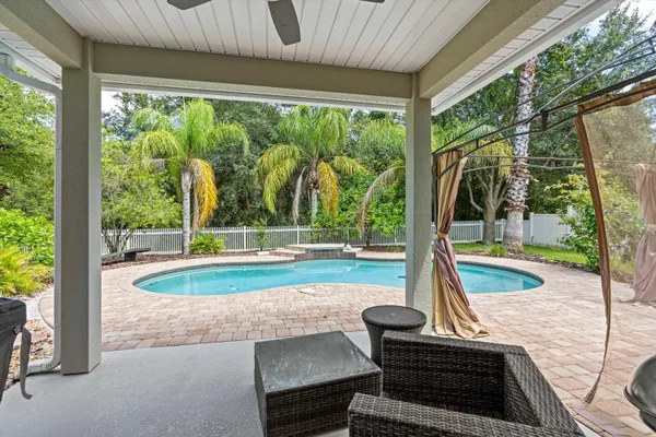 a view of a patio with a table chairs and a backyard