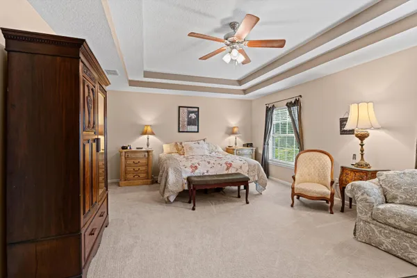a bedroom with furniture and a window
