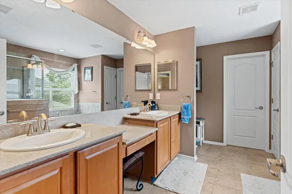a spacious bathroom with a sink double vanity and a mirror