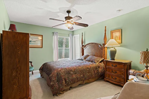 a bedroom with a bed and dresser with mirror