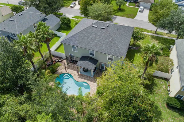 an aerial view of a house with yard swimming pool and outdoor seating