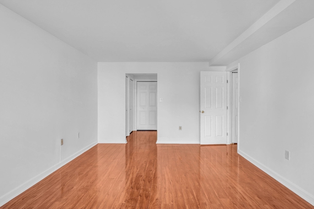 1 Commodore Court, Unit 202 Hull, MA 02045 - Photo 14 of 35 a view of room with wooden floor
