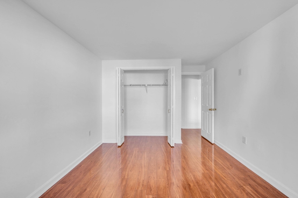 1 Commodore Court, Unit 202 Hull, MA 02045 - Photo 15 of 35 a view of a room with wooden floor