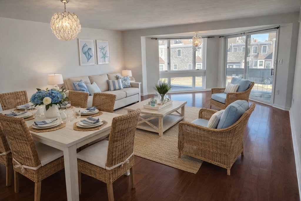 1 Commodore Court, Unit 202 Hull, MA 02045 - Photo 3 of 35 a living room with furniture a table and a large window