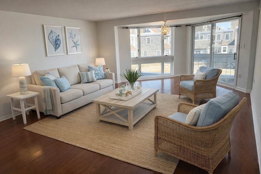 1 Commodore Court, Unit 202 Hull, MA 02045 - Photo 4 of 35 a living room with furniture and a large window