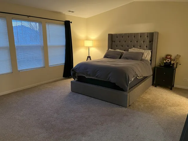 a bedroom with a bed and window