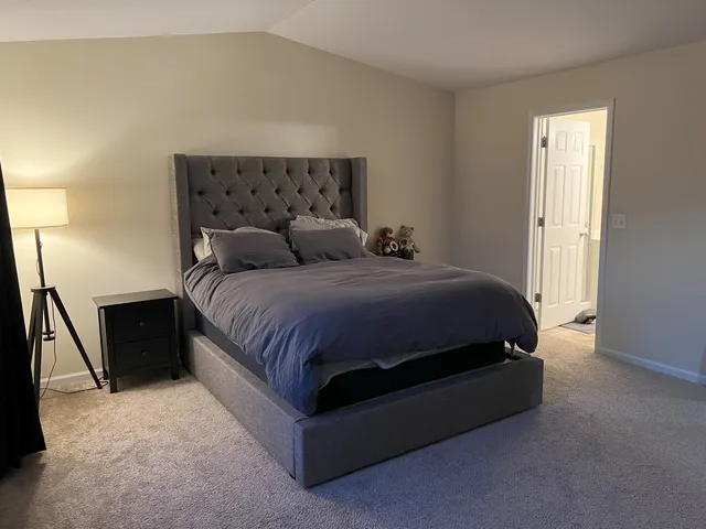 a bedroom with a bed and a dresser