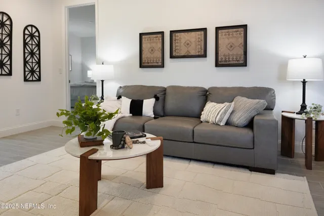 a dining room with furniture and a potted plant