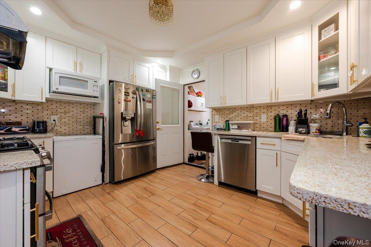 116-22 127th Street Queens, NY 11420 - Photo 5 of 18 a kitchen with a sink appliances and cabinets