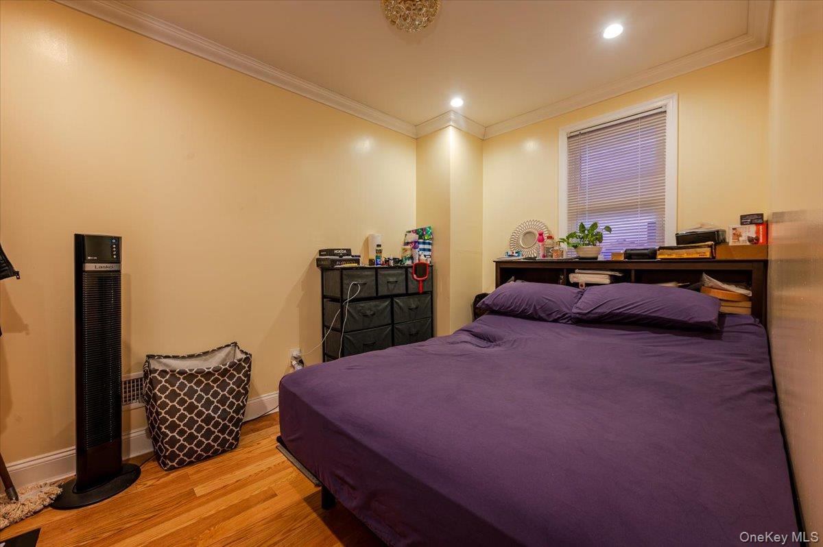 116-22 127th Street Queens, NY 11420 - Photo 7 of 18 a bed room with a bed window and dresser