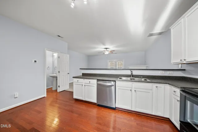 a kitchen with stainless steel appliances granite countertop a sink and cabinets