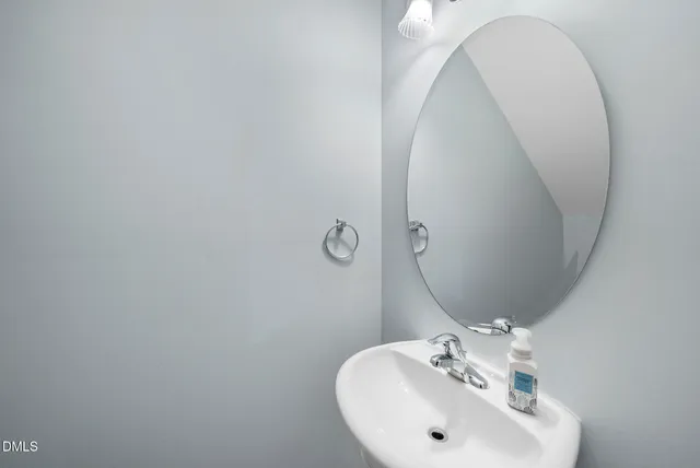 a bathroom with a sink and mirror
