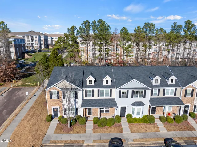 a front view of a residential apartment building with a yard