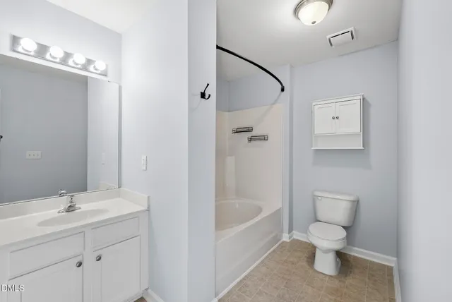 a bathroom with a toilet a sink and bathtub