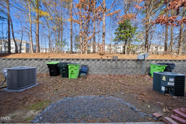 a view of backyard with table and chairs