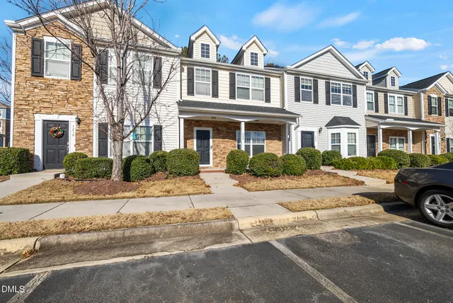 a car parked in front of a brick house
