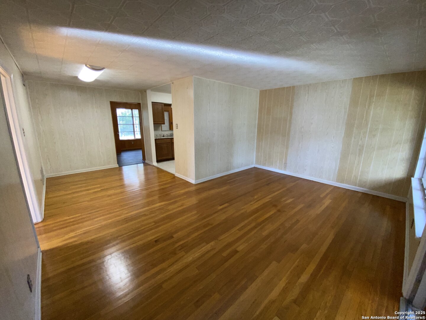 618 East Rector Street San Antonio, TX 78216 - Photo 13 of 24 a view of an empty room with window and wooden floor