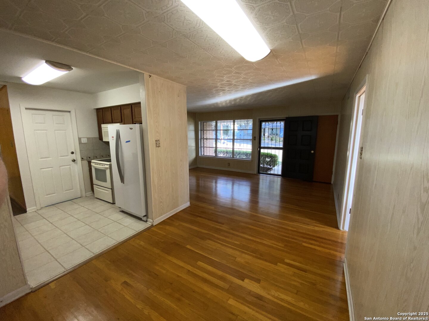 618 East Rector Street San Antonio, TX 78216 - Photo 14 of 24 a view of a hallway with wooden floor and a living room