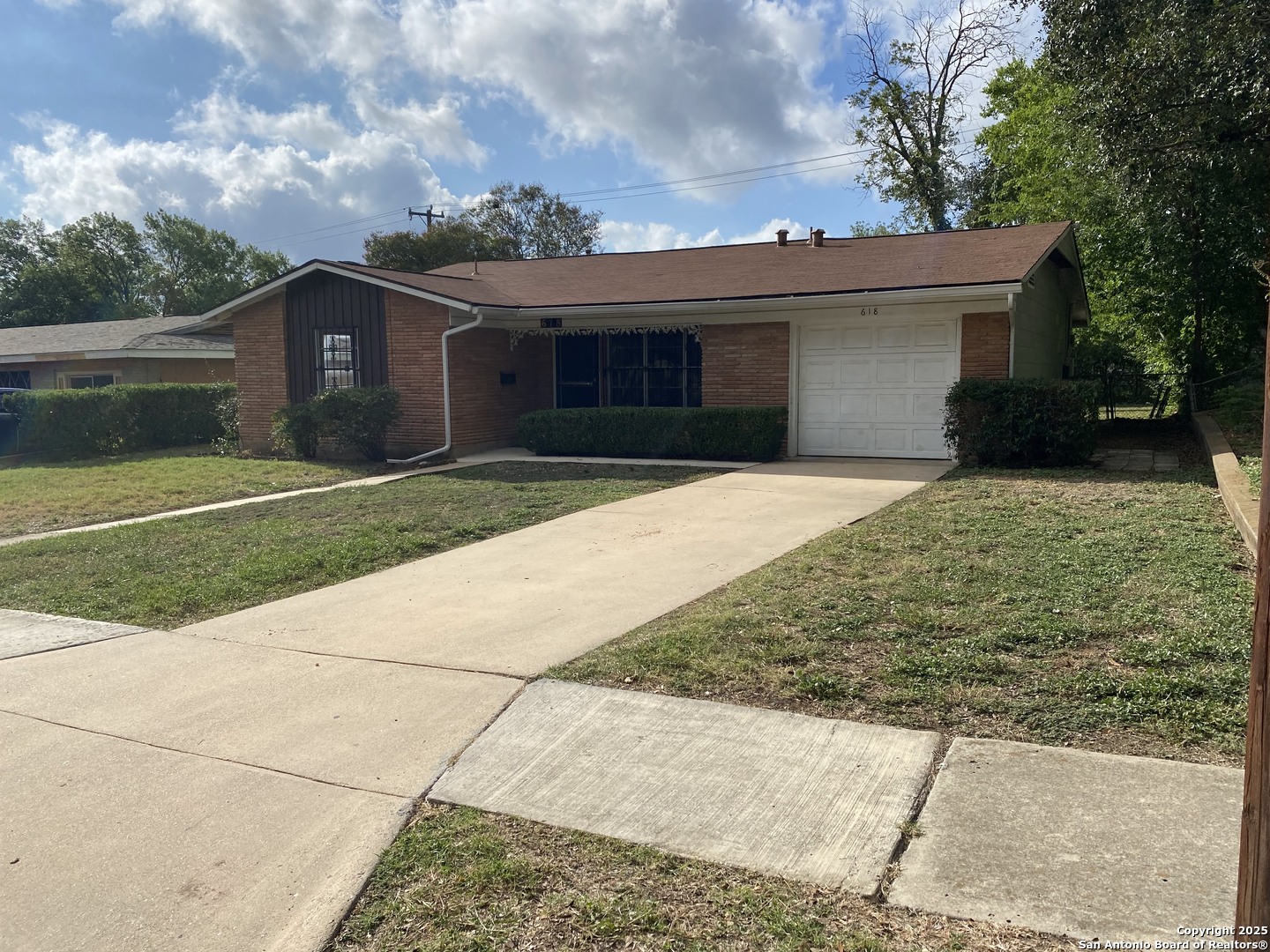 618 East Rector Street San Antonio, TX 78216 - Photo 2 of 24 a front view of a house with a yard and garage