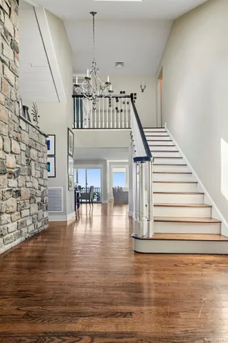 a view of entryway and hall with wooden floor