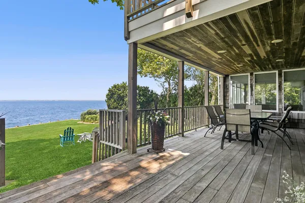 a view of a chairs and table on the wooden deck