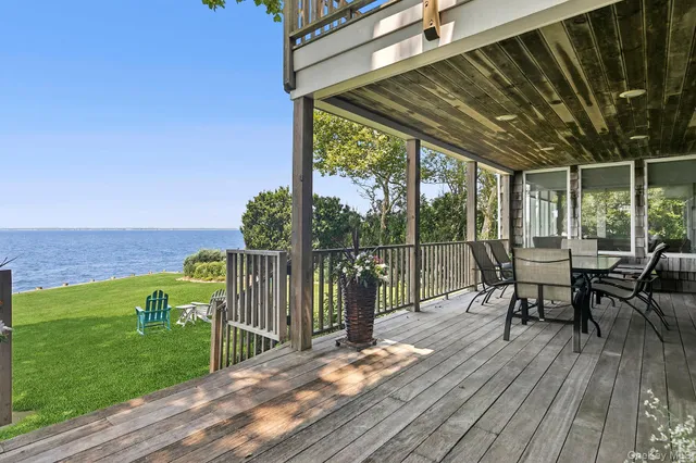 a view of a chairs and table on the wooden deck
