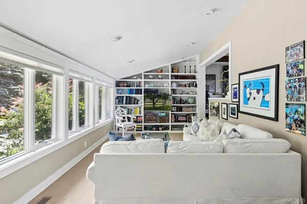 a living room with furniture and large windows