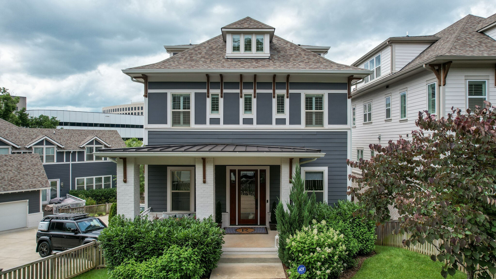 front view of a brick house with a yard