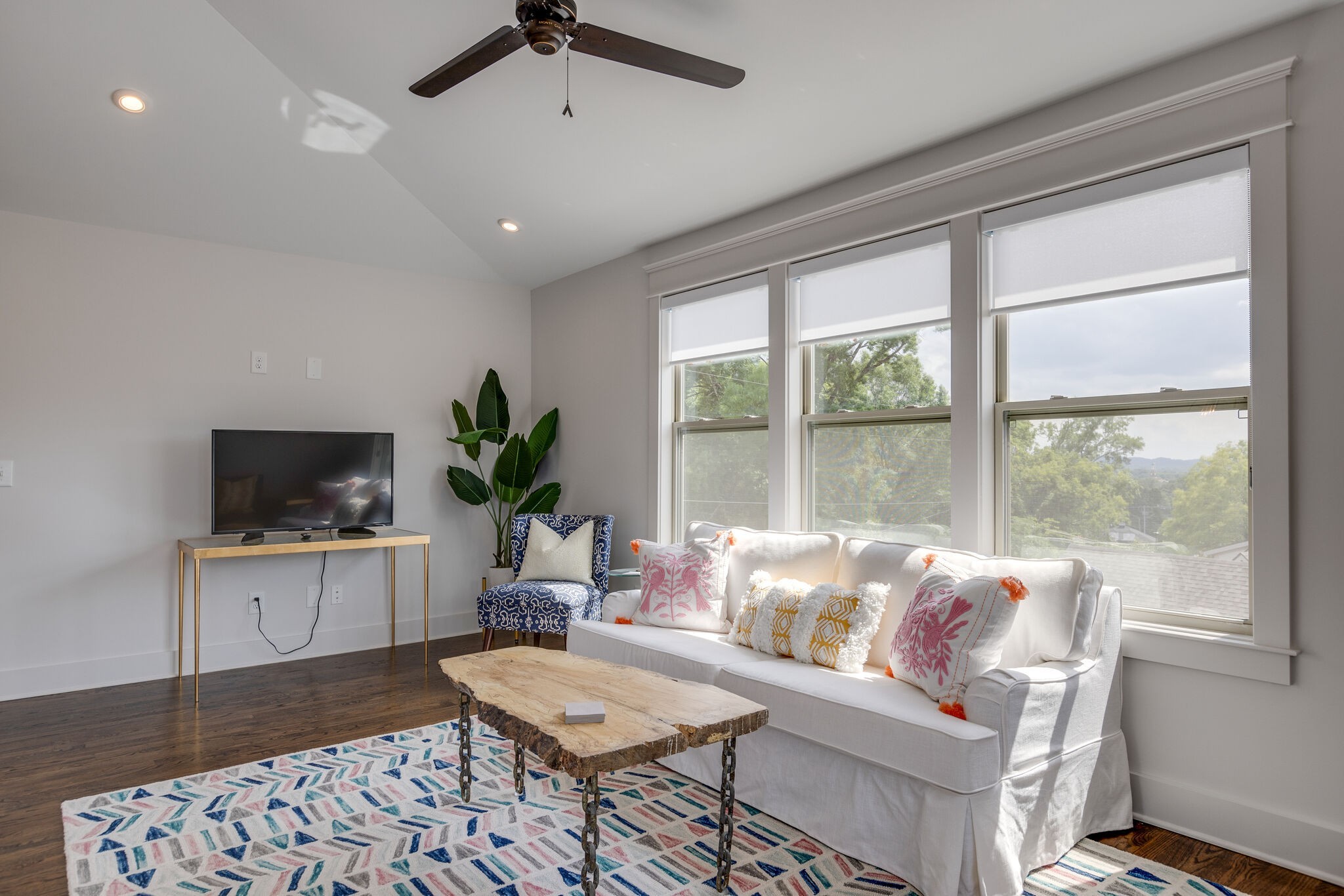 3406 Love Circle Nashville, TN 37212 - Photo 33 of 40 a living room with furniture a flat screen tv and a large window