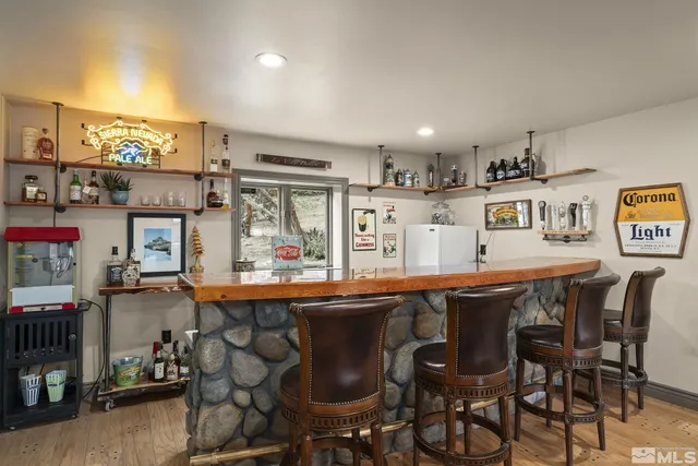 a dining hall view with stainless steel appliances granite countertop a dining table and chairs
