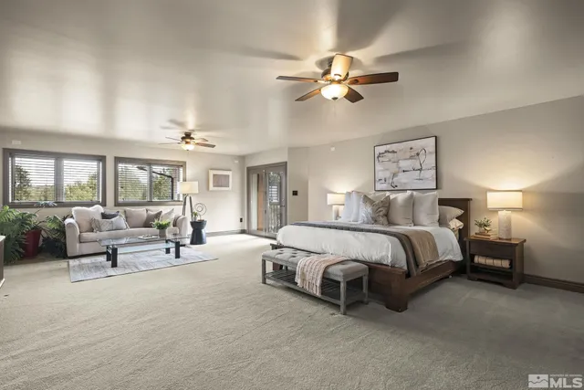 a spacious bedroom with a bed and a chandelier