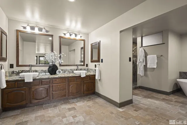 a bathroom with a sink a mirror and a shower