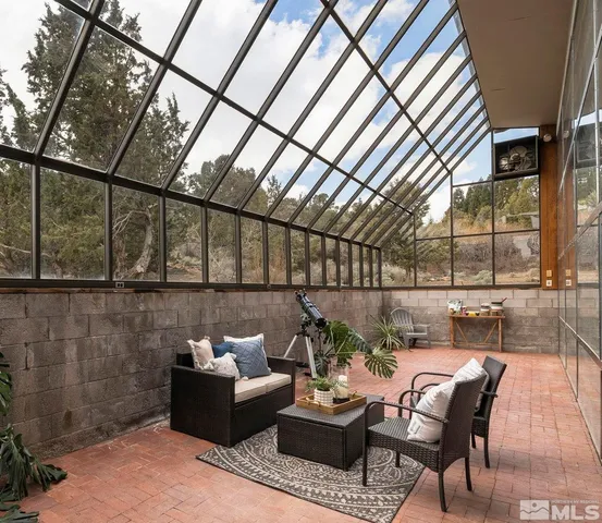 a view of a tables and chairs on the roof deck