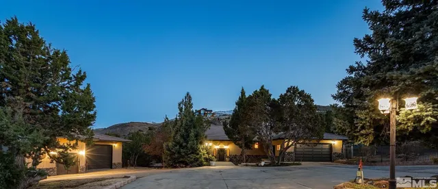 a front view of a house with garden and patio