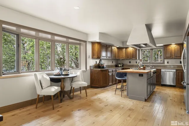 a kitchen with a table chairs microwave and cabinets