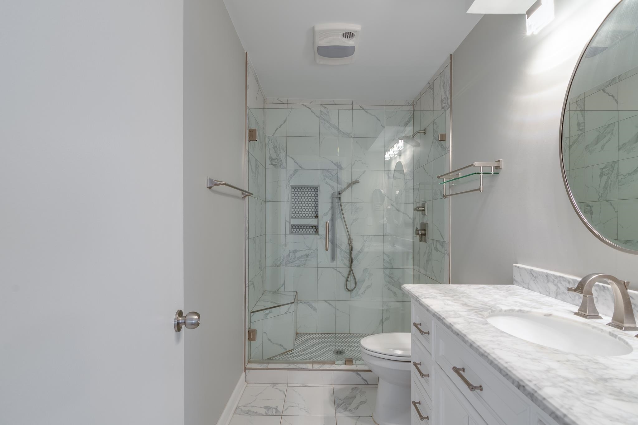 971 June Road, Unit 7 Memphis, TN 38119 - Photo 18 of 23 Full bathroom with toilet, vanity, a marble finish shower, marble finish floor, and baseboards