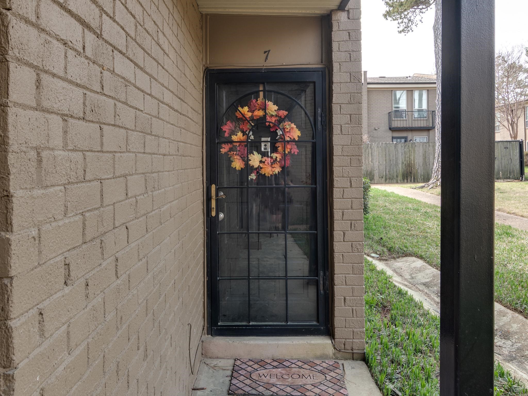 971 June Road, Unit 7 Memphis, TN 38119 - Photo 2 of 23 Property entrance with fence and brick siding