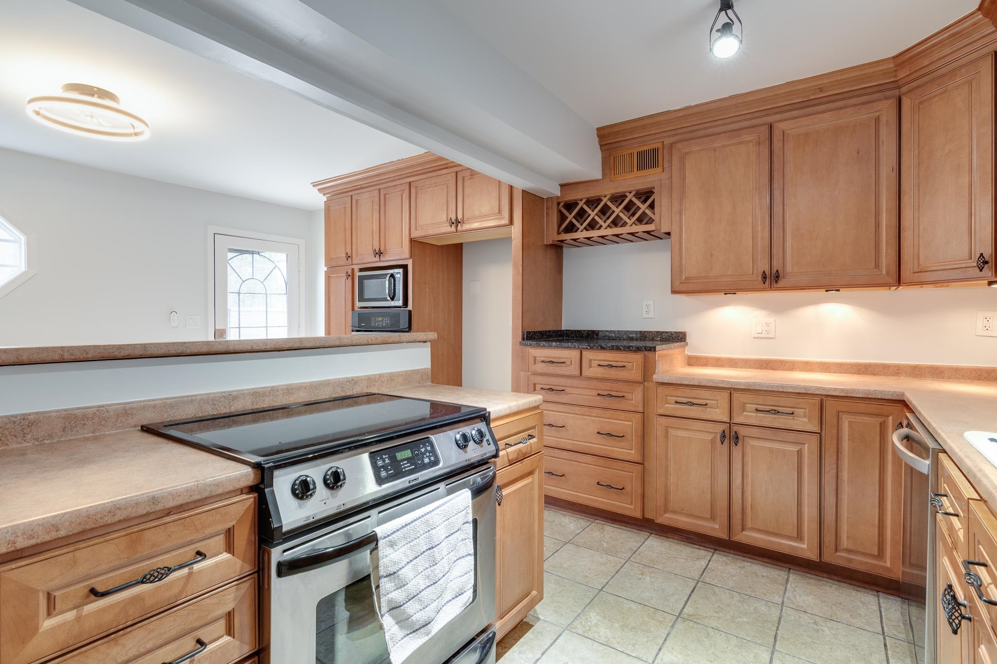 971 June Road, Unit 7 Memphis, TN 38119 - Photo 7 of 23 Kitchen with light countertops, light tile patterned floors, and stainless steel appliances