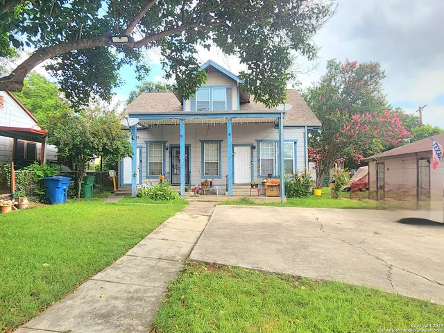 a front view of a house with yard porch and outdoor seating