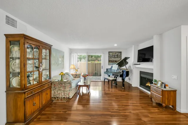 a living room with fireplace furniture and a flat screen tv