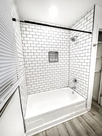 a bathroom with a bathtub and shower